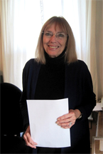 Photograph of Sam Oliver standing in her office