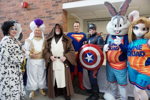 A group of costumed characters poses together at Fandom Fest