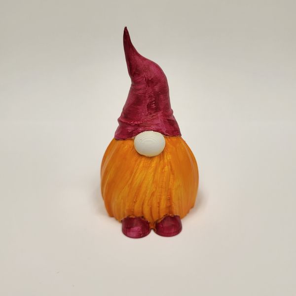 Gnome printed in yellow filament, primed in white acrylic, and then details added in red and orange acrylic paint.
