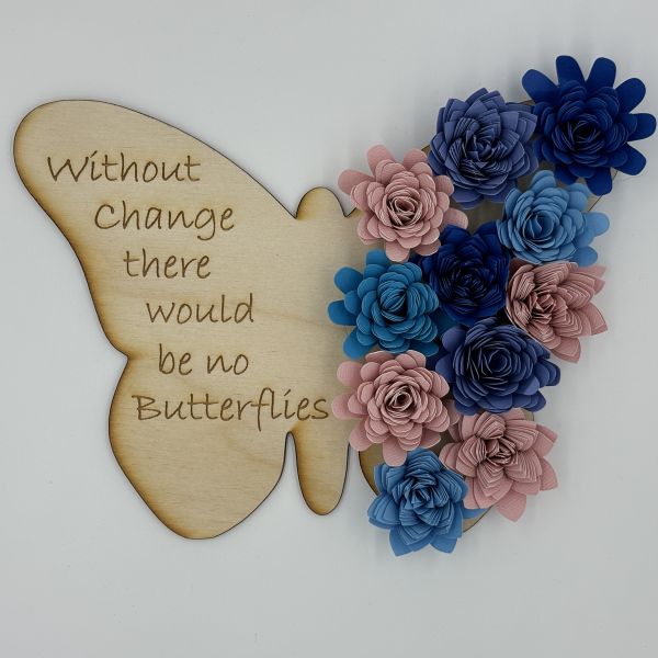 Butterfly with phrase Without change there would be no butterflies etched on the left wing. Ten paper flowers in blues and pinks glued to the right wing.
