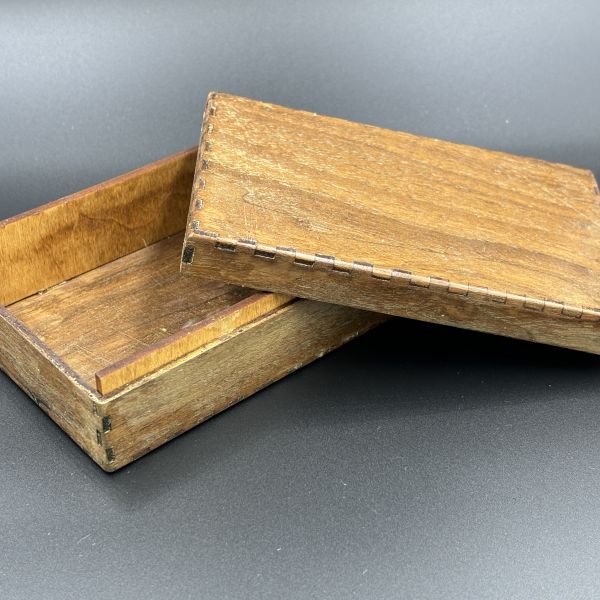 Assembled rectangle box cut out on walnut wood.
