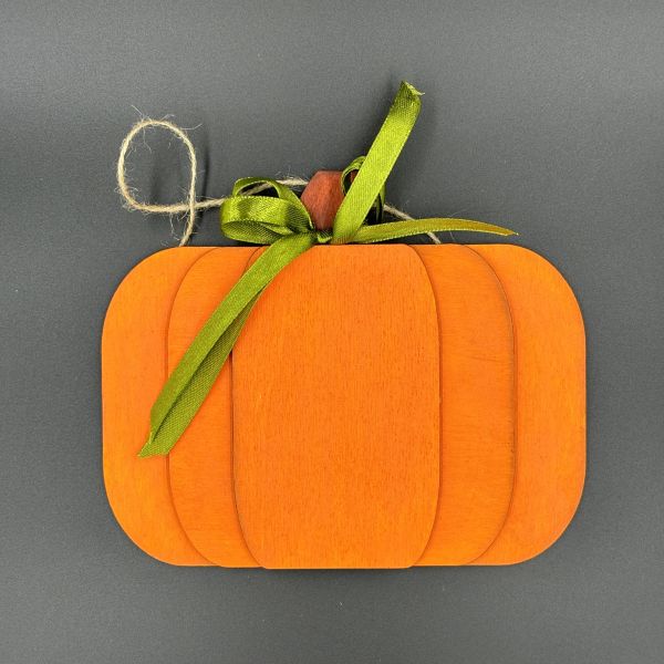 Layered pumpkin painted orange with a green bow on top and a twine hanger.