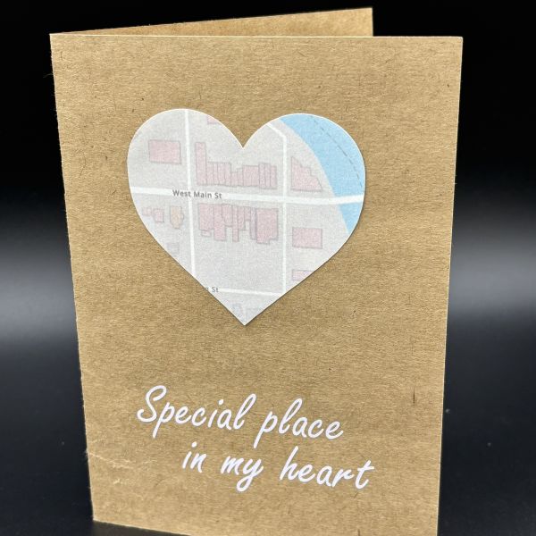 Print-then-cut image of a map created with registration marks, cut in the shape of a heart, and glued in the middle of the card. White vinyl below the print-then-cut map image says special place in my heart.